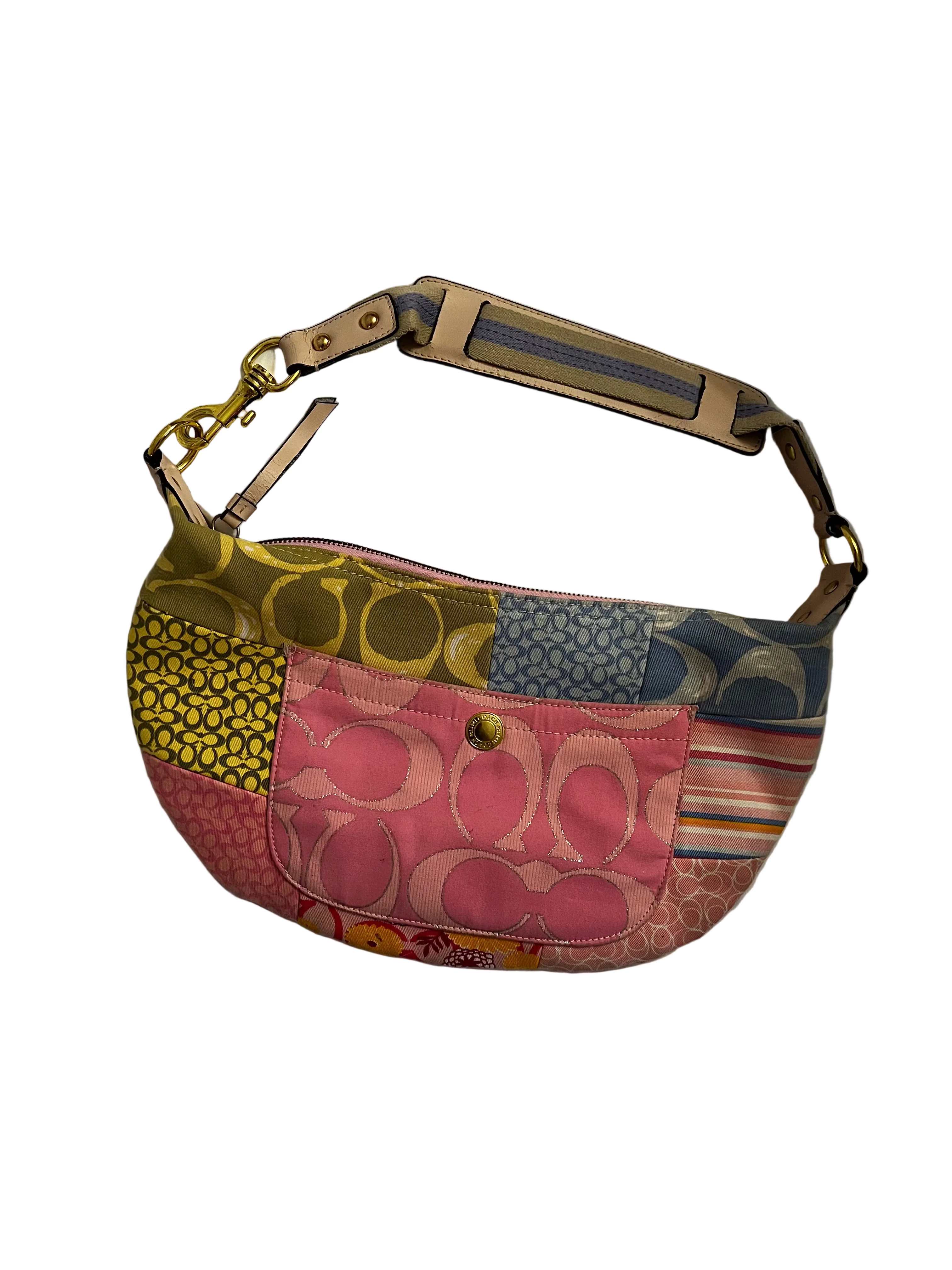Multicolored coach patterned handbag on a white surface